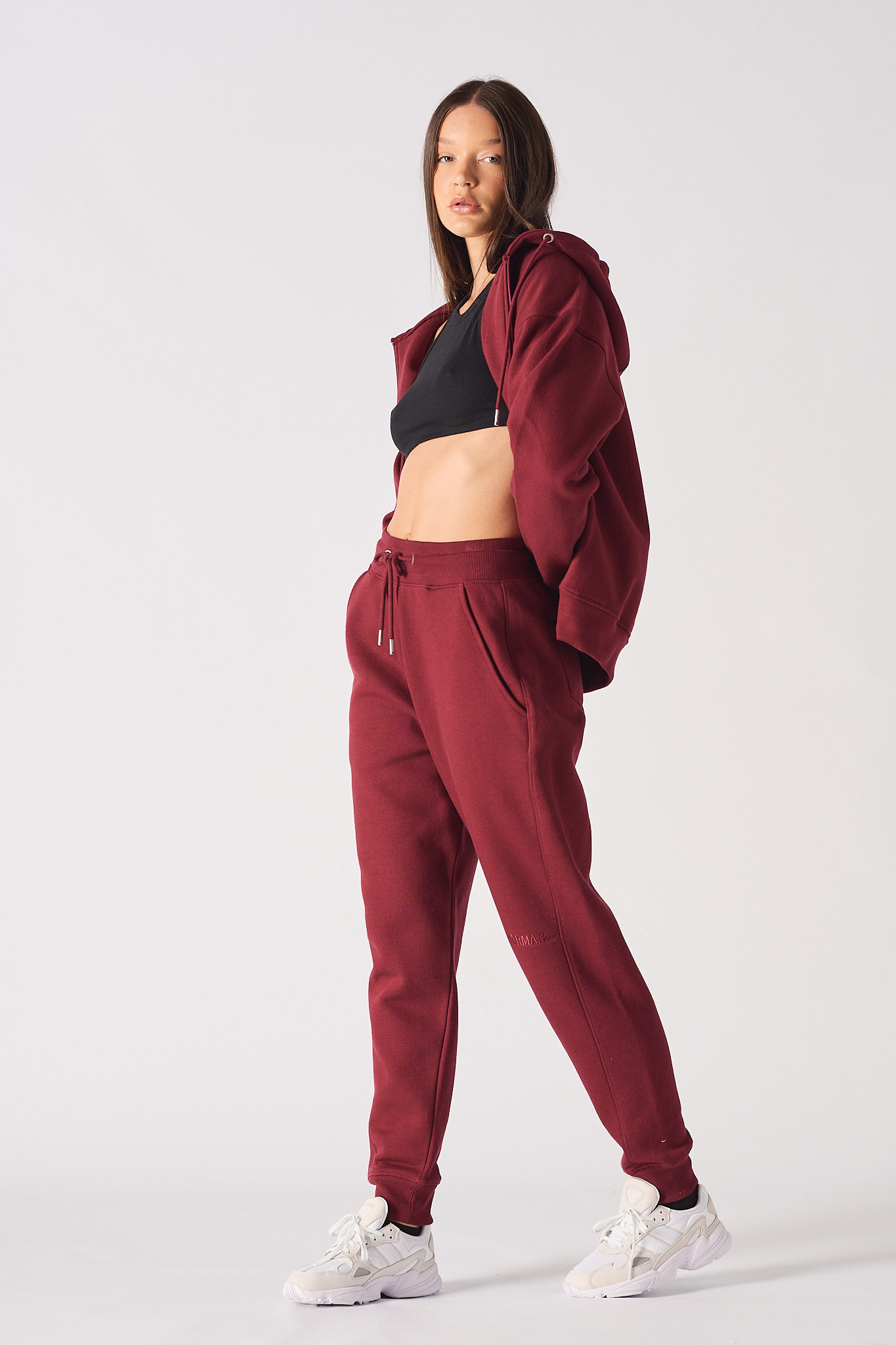 Back view of burgundy tapered joggers showing pocket placement and fit