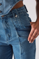 Close-up of the front pocket and utility loop on the cargo denim jeans for women.