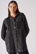 Close-up of the women's contrast panel acid wash denim shirt.