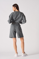 Rear view of womens relaxed fit fleece shorts in cool grey