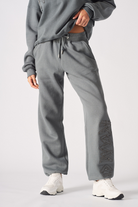 Full front view of a model wearing the cuffed leg joggers in grey.
