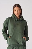 Close up of the hood neck on a womens dark green sweatshirt