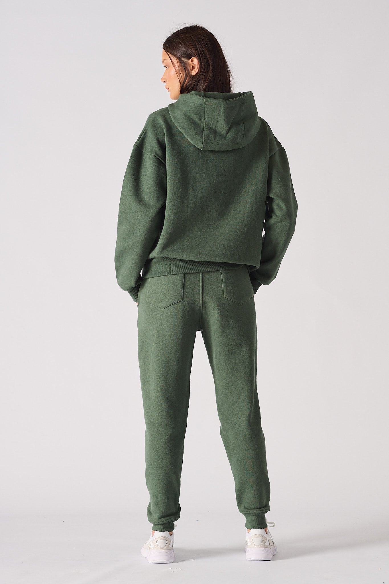 Rear view of womens dark green hoodie with relaxed fit