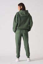 Rear view of womens dark green hoodie with relaxed fit