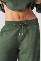 Close-up of the drawstring waist on the dark green joggers for women.