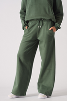 Close-up of the dark green joggers for women showing the wide-leg fit.