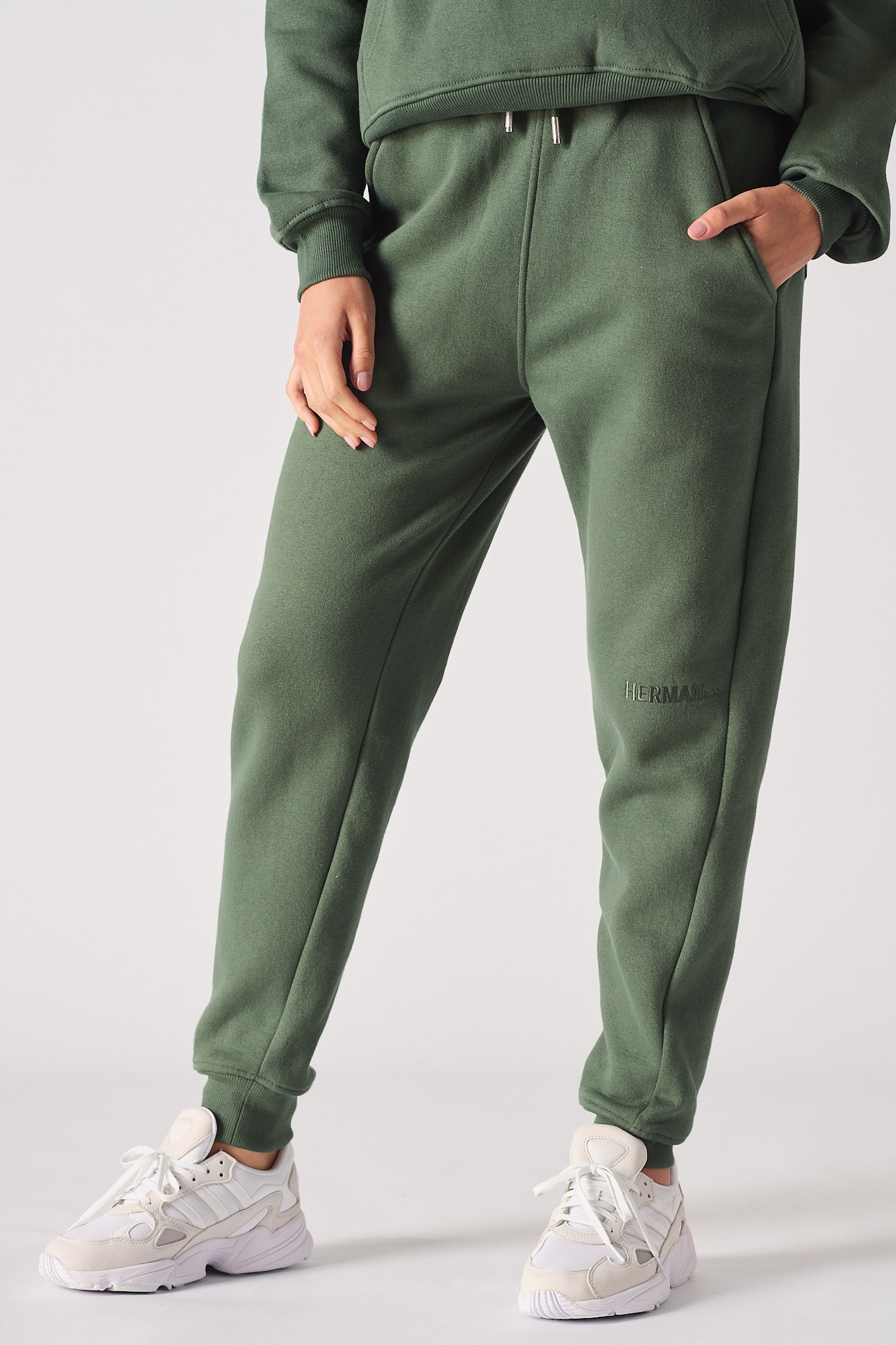 Front close-up view of the dark green tapered joggers for women.