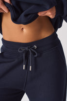 Close-up of the drawstring waist on the dark navy joggers for women.