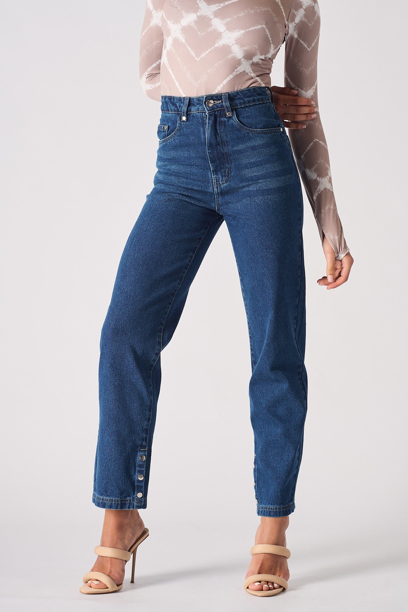 Close-up of the women's dark wash straight leg jeans with a whisker effect.