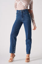 Close-up of the women's dark wash straight leg jeans with a whisker effect.