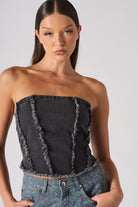 Close-up of a model wearing the distressed black wash strapless corset top.