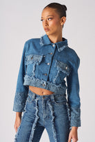 Angled front view of the distressed two-tone denim crop jacket.