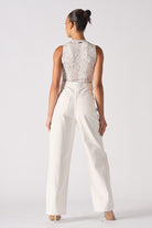 Back view of a model wearing the distressed white jeans for women.