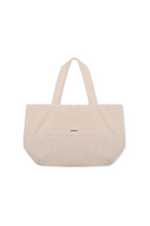 The ecru tote bag with a branded logo tab, laid flat