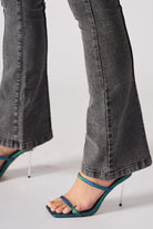 Close-up of the flared hem on the grey jeans.