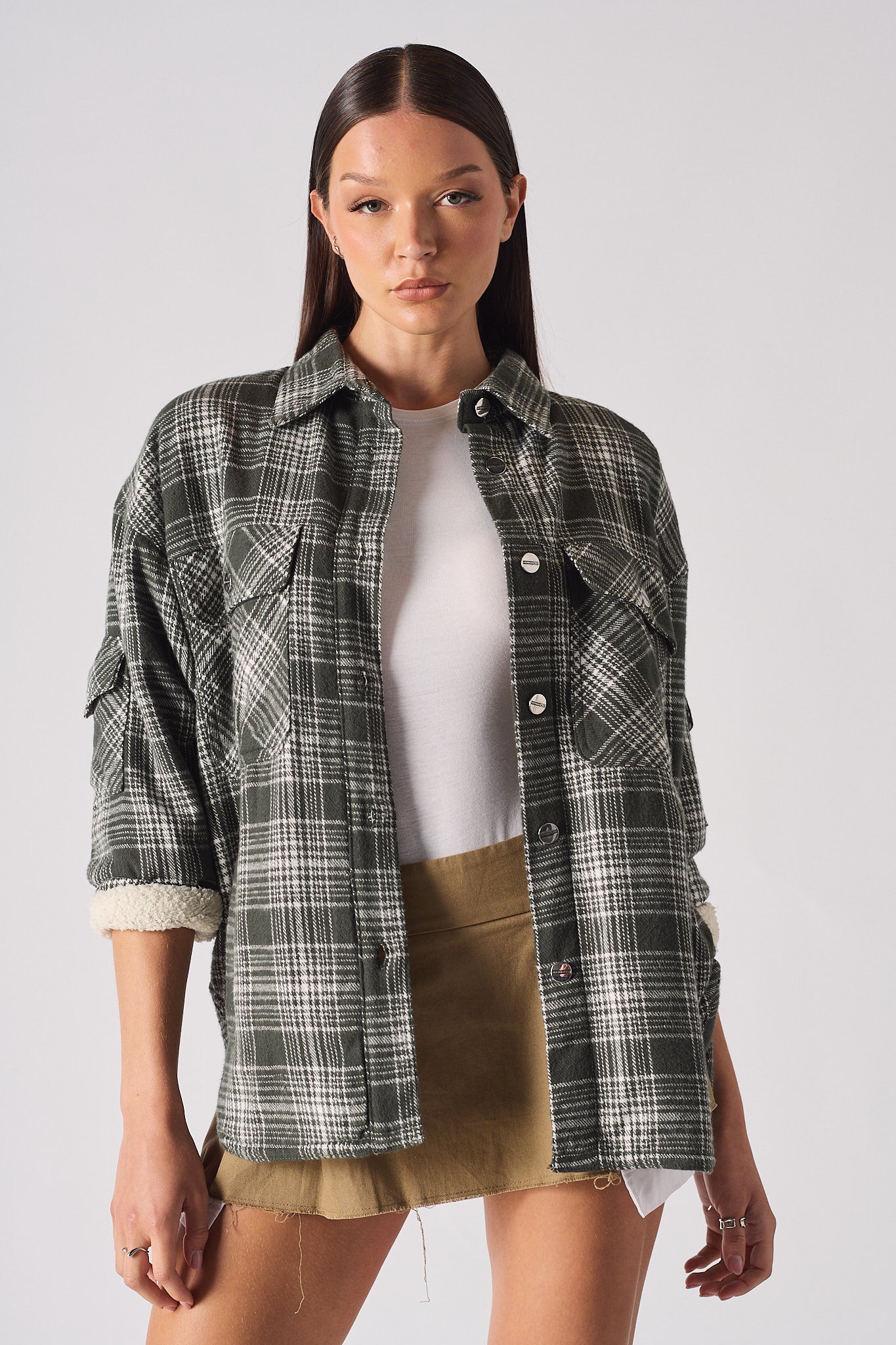 Close-up of a model wearing the green check oversized shirt for women.