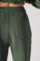 Close-up of the back pocket on the women's green tapered joggers.
