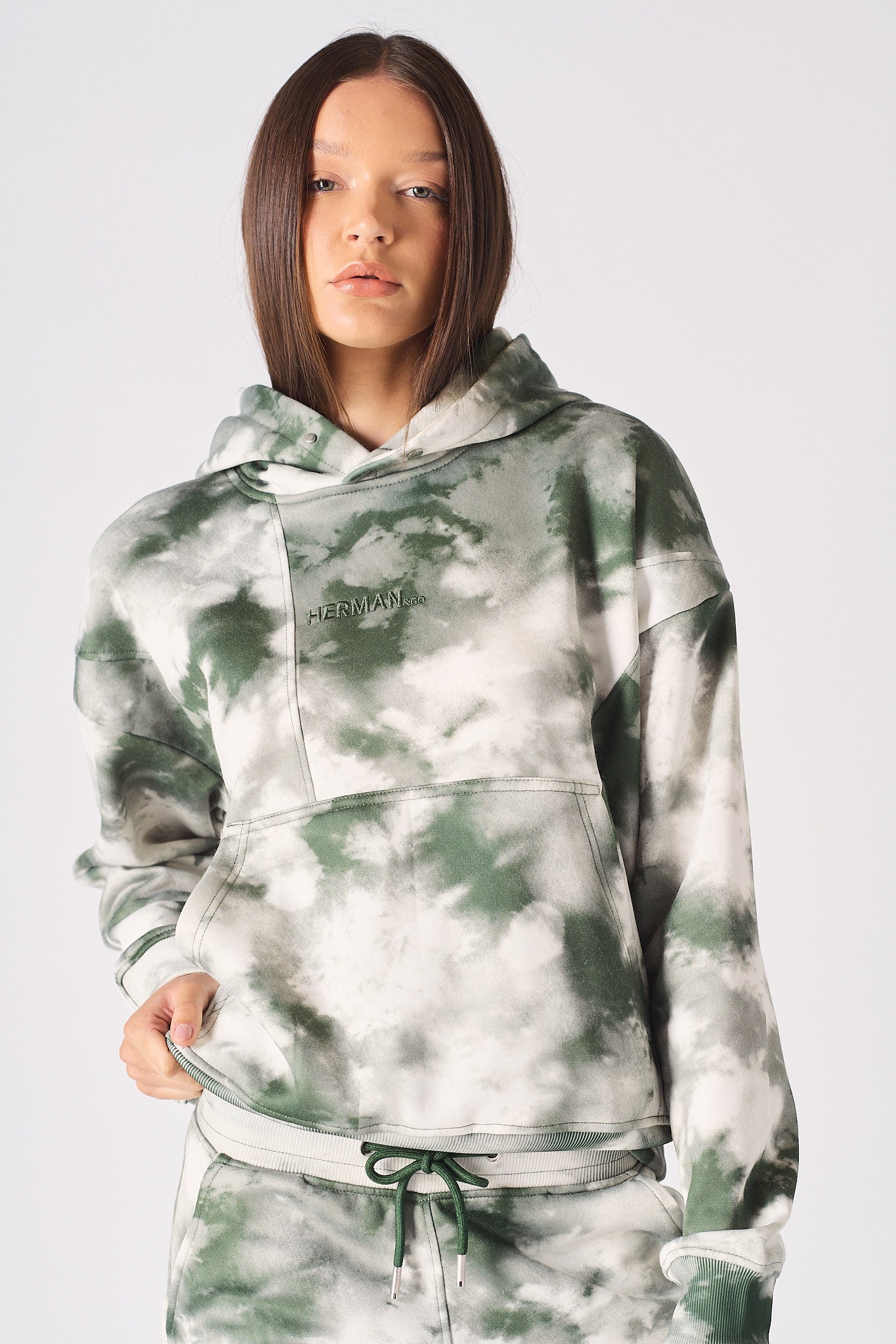 Close up texture view of the abstract green and cream tie dye fabric pattern