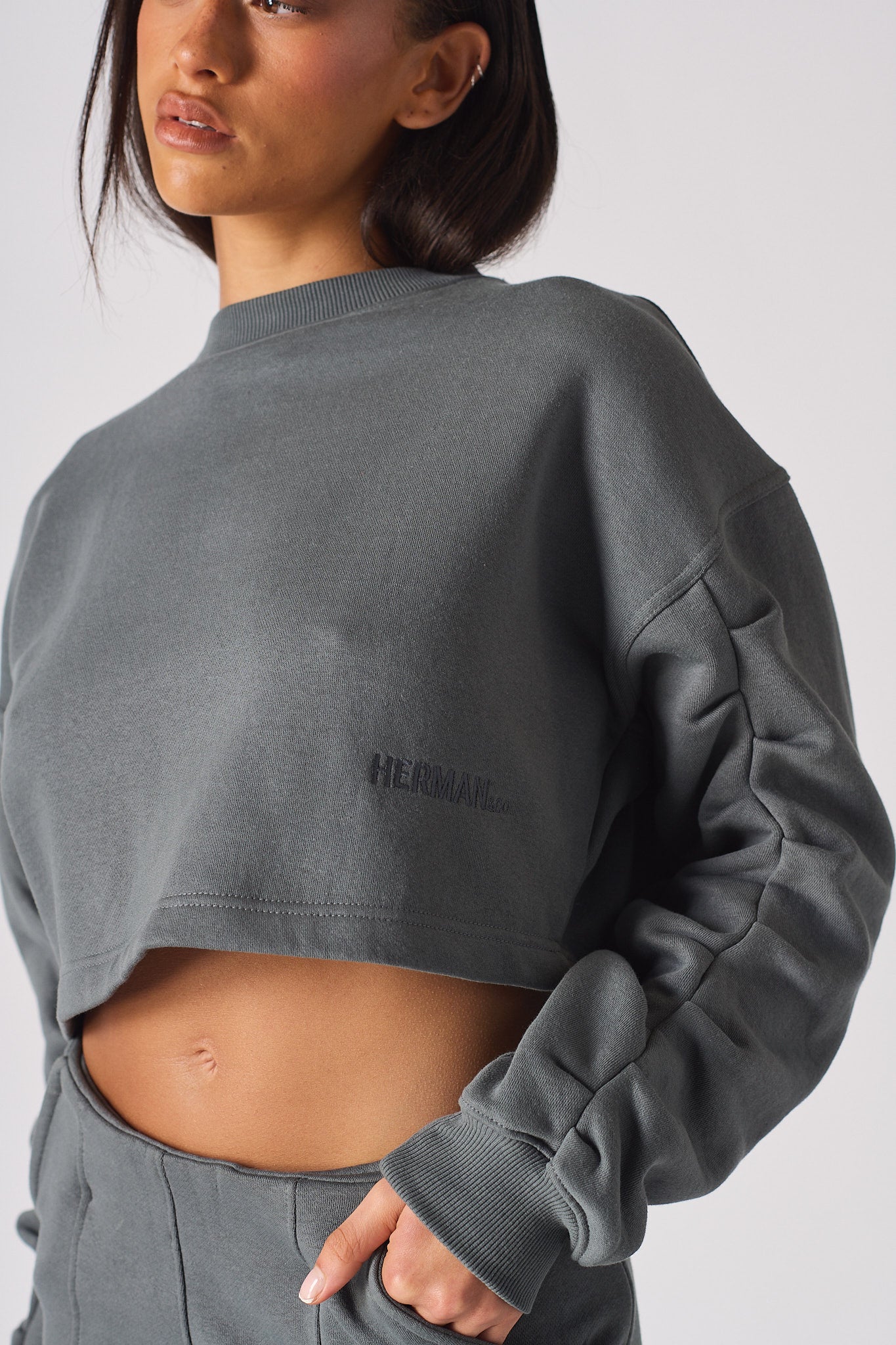 Close up of the high crew neck on womens grey jumper