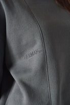Extreme close up showing the premium soft cotton texture of grey jumper