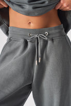 Close-up of the drawstring waist on the women's grey cuffed joggers.