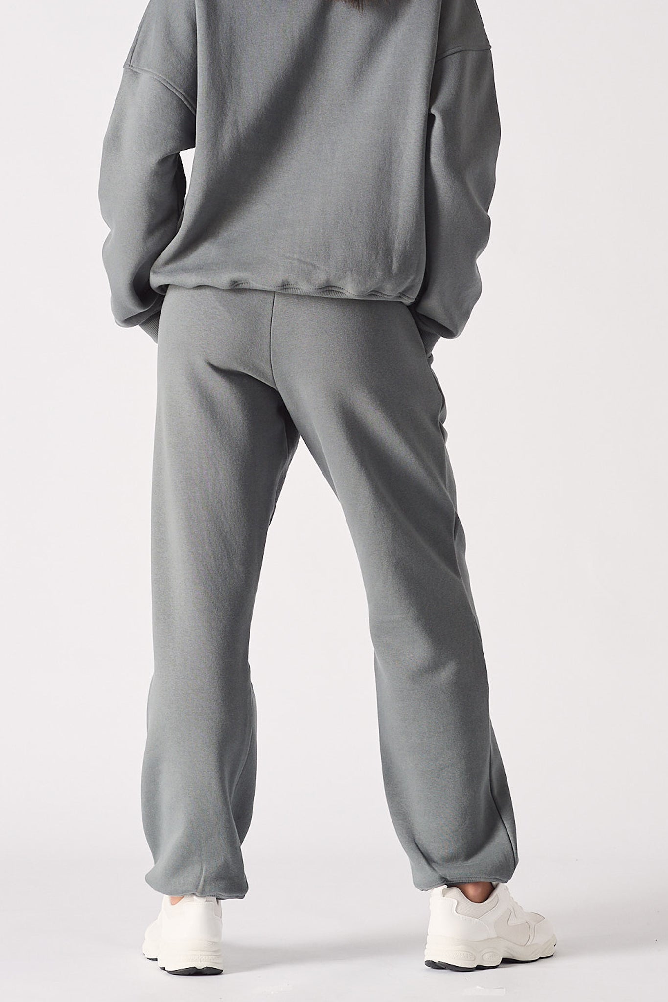 Back view of a model wearing the grey cuffed leg joggers.