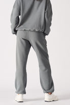 Back view of a model wearing the grey cuffed leg joggers.