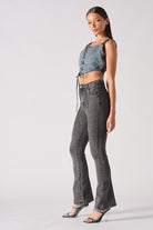 Side profile of a model wearing the grey fit and flare jeans.