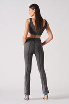 Back view of a model in the grey flare jeans.