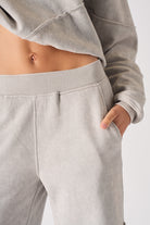 Close-up of the side pocket on the grey joggers with seam detail.