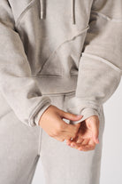 Close up detail of the ribbed sleeve cuff and seam stitching on womens grey hoodie