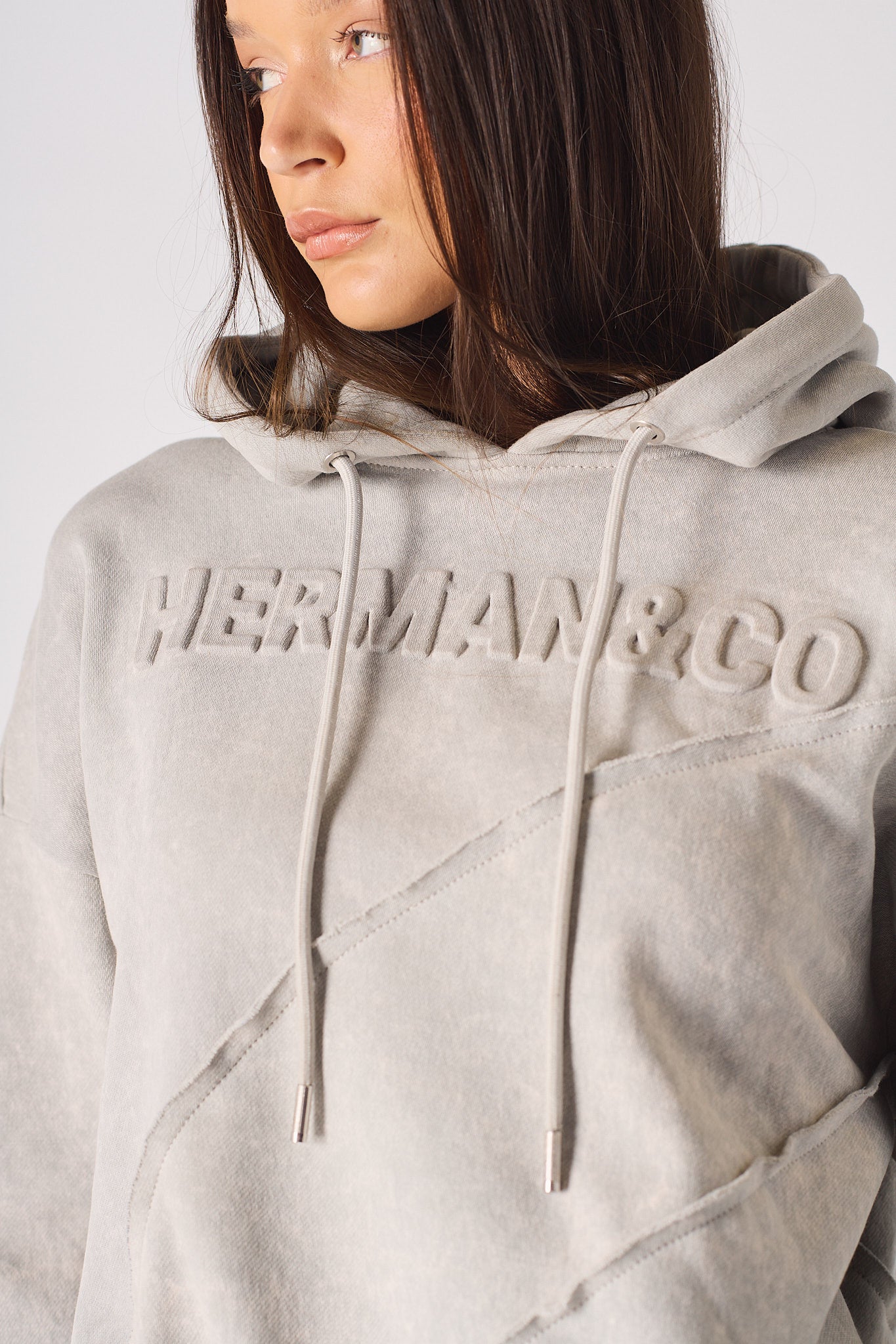 Detailed view of the hood and neckline structure on womens grey oversized hoodie