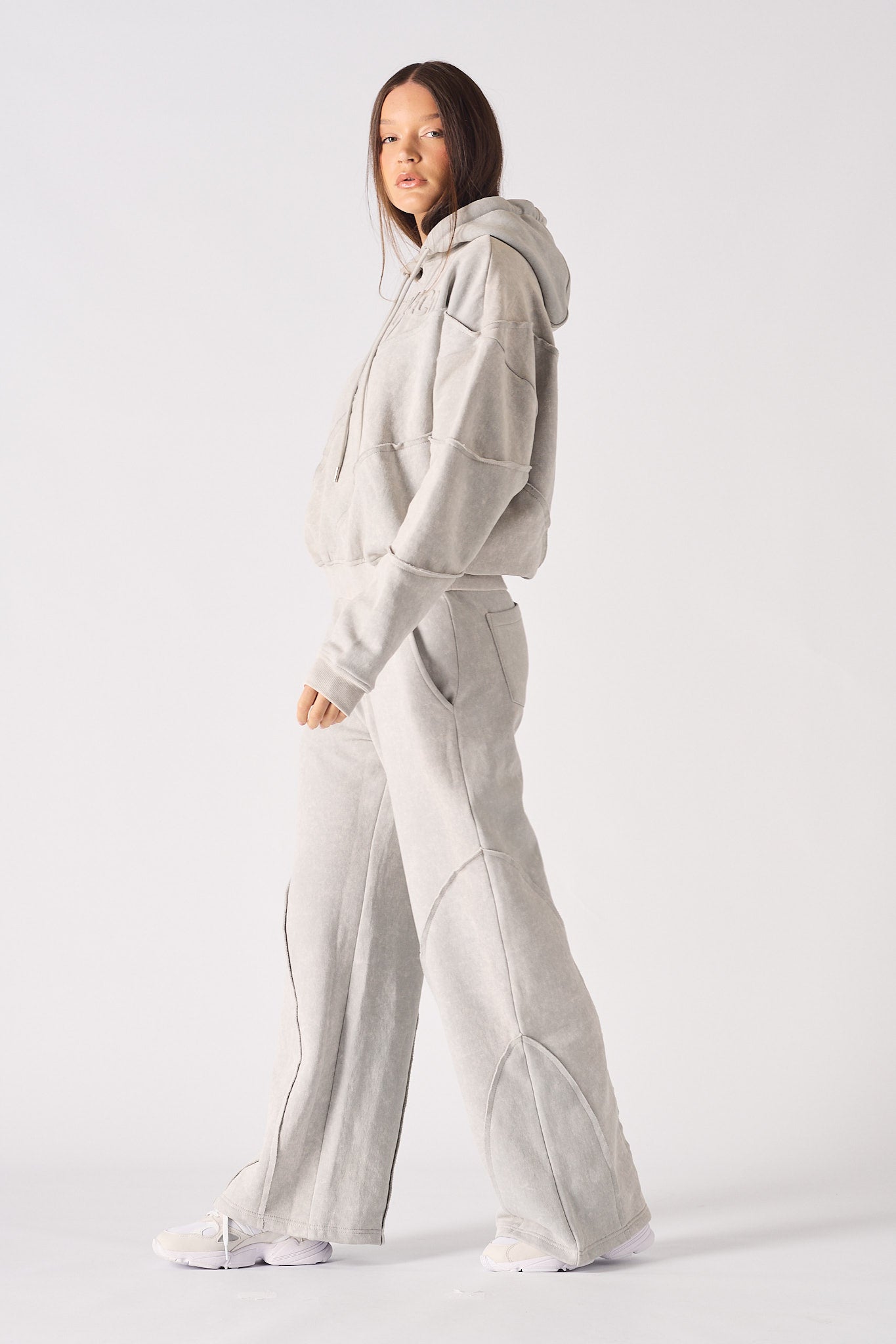 Side profile view showing the loose comfortable fit of the womens oversized grey hoodie