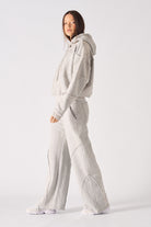 Side profile view showing the loose comfortable fit of the womens oversized grey hoodie