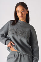 Detailed view of the high crew neck structure on womens grey oversized sweatshirt