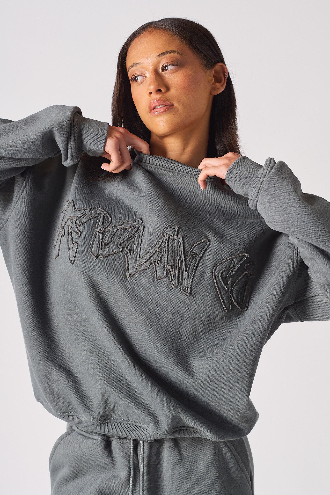 Side profile view showing the loose comfortable fit of the womens oversized grey sweatshirt