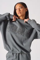 Side profile view showing the loose comfortable fit of the womens oversized grey sweatshirt
