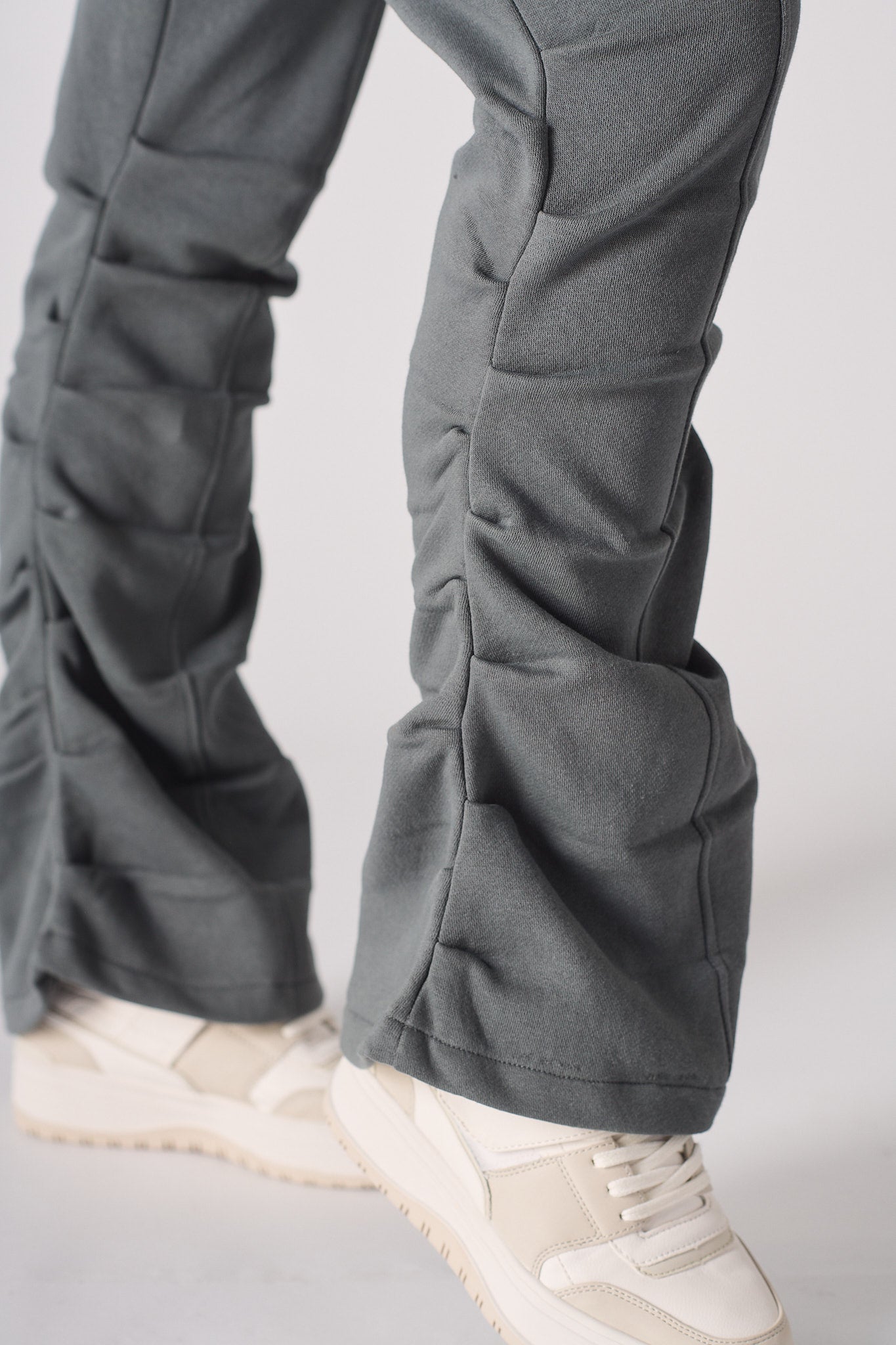 Model standing in grey ruched flare joggers showing the front fit