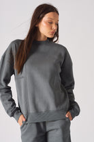 Close up detail of the HERMAN logo embroidery on the chest