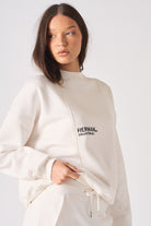 Close up detail of the small black logo printed on the chest