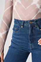 Close-up of the front pocket and whisker detail on the jeans.