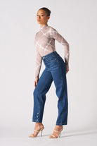 Side view of a model showing the fit of the jeans with whiskers.