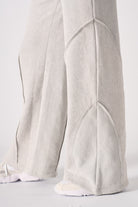 Close-up of the hem and seam detail on the grey joggers.