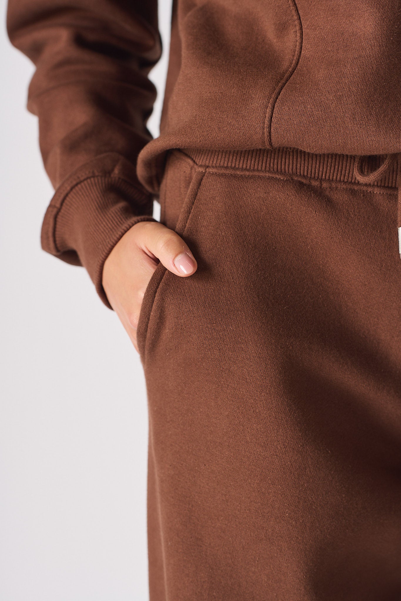 Close-up of the side pocket detail on the ladies' brown joggers.