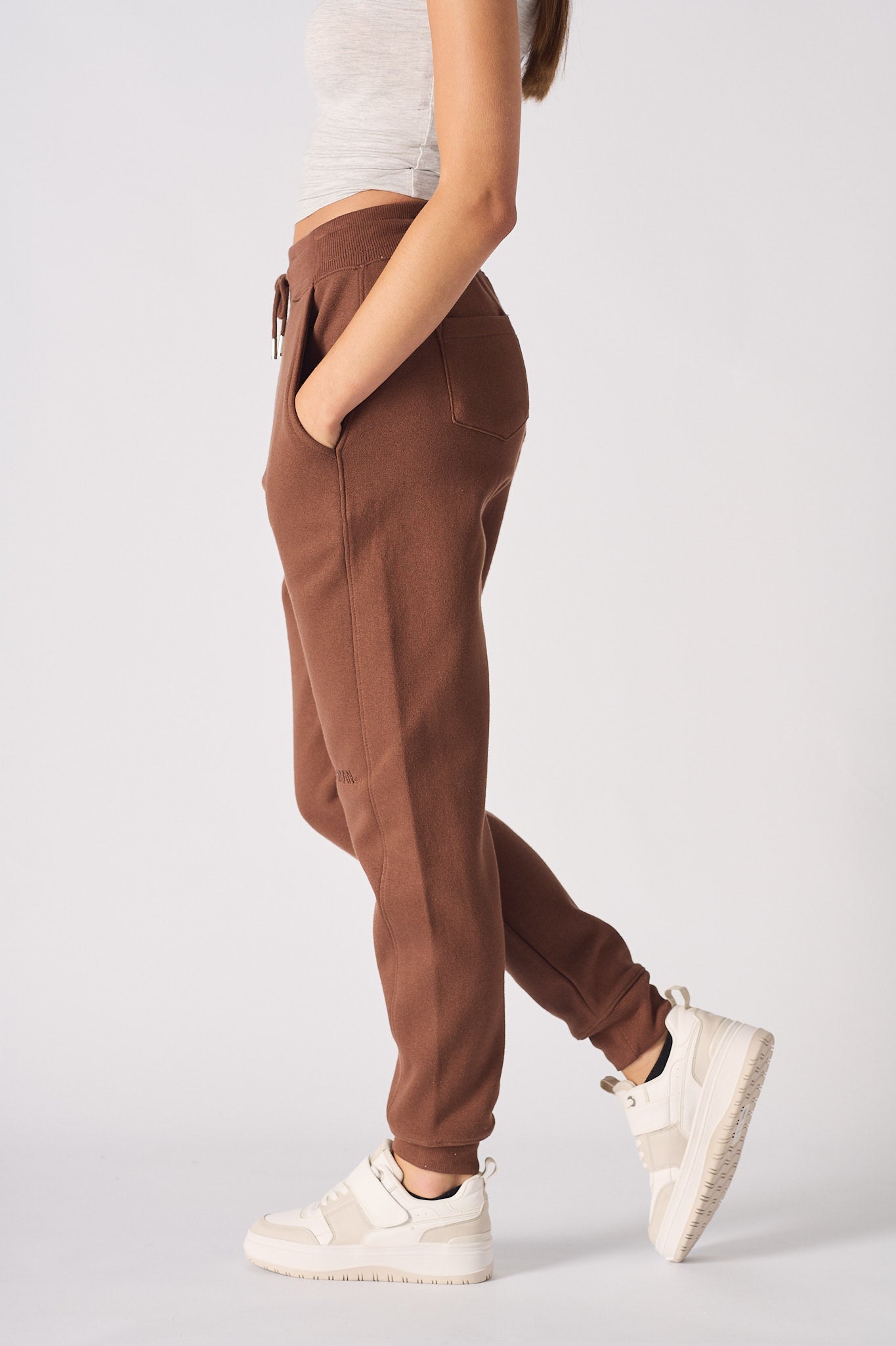 Side profile of the ladies' brown tapered joggers showing the slim fit.