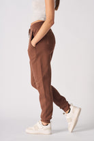 Side profile of the ladies' brown tapered joggers showing the slim fit.