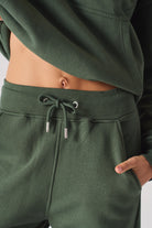 Close-up of the drawstring waist on the ladies' green tapered joggers.