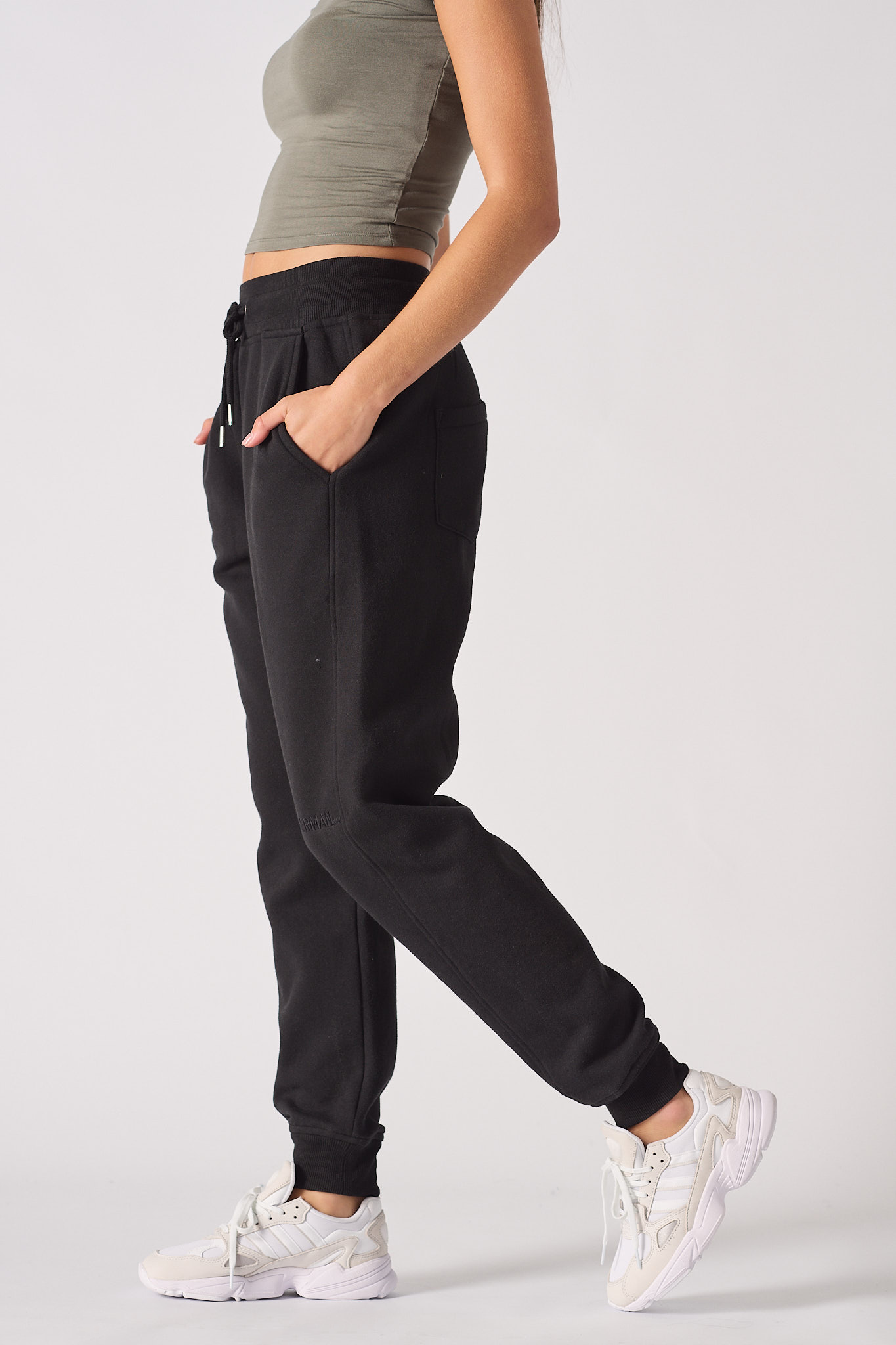 Side profile of the ladies' black tapered joggers to show the tapered leg