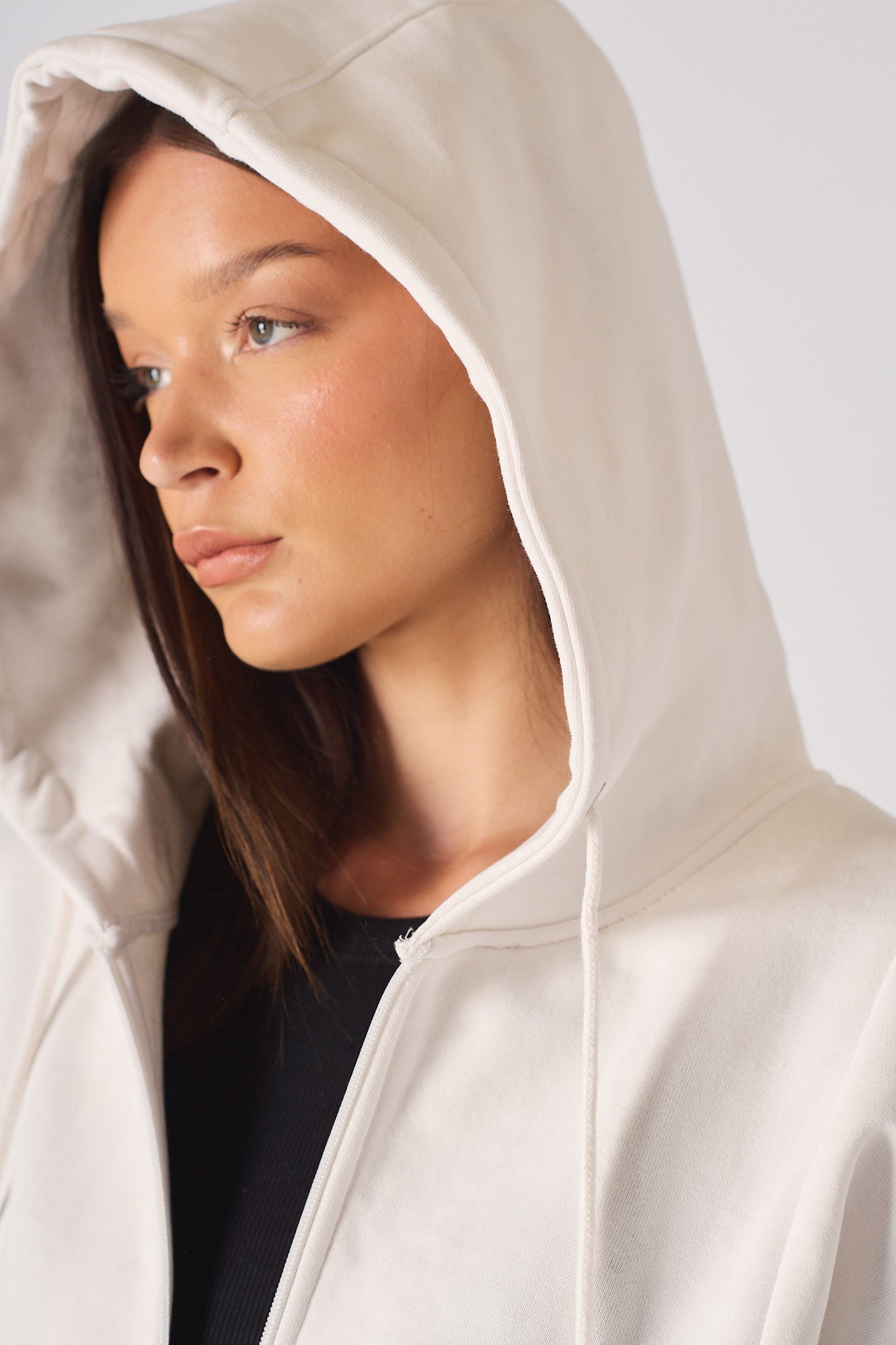 Close-up of the hood on the ladies' white zip-up hoodie.