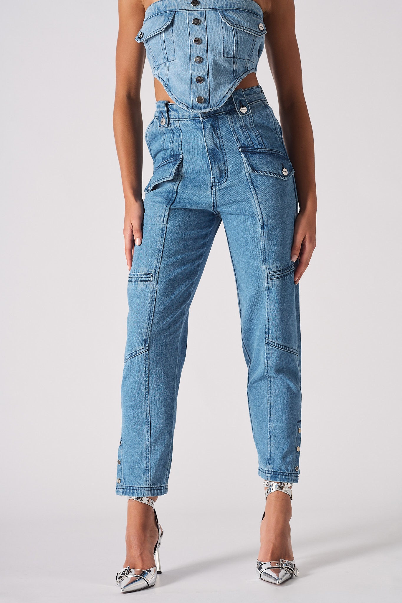 Front close-up of the women's mid-wash cargo denim jeans.